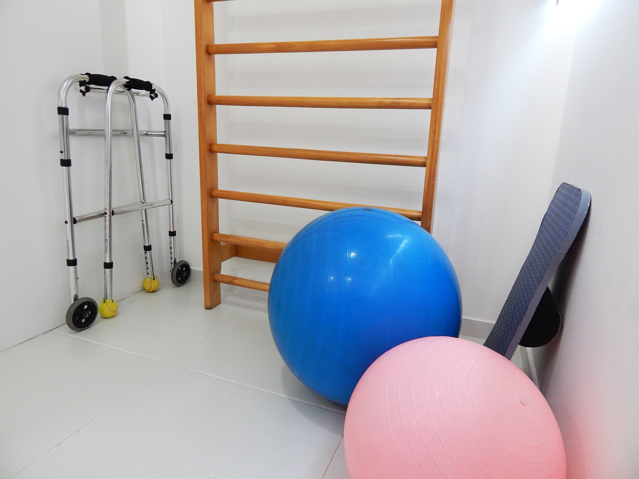 Walker, ladder, and exercise balls in a room