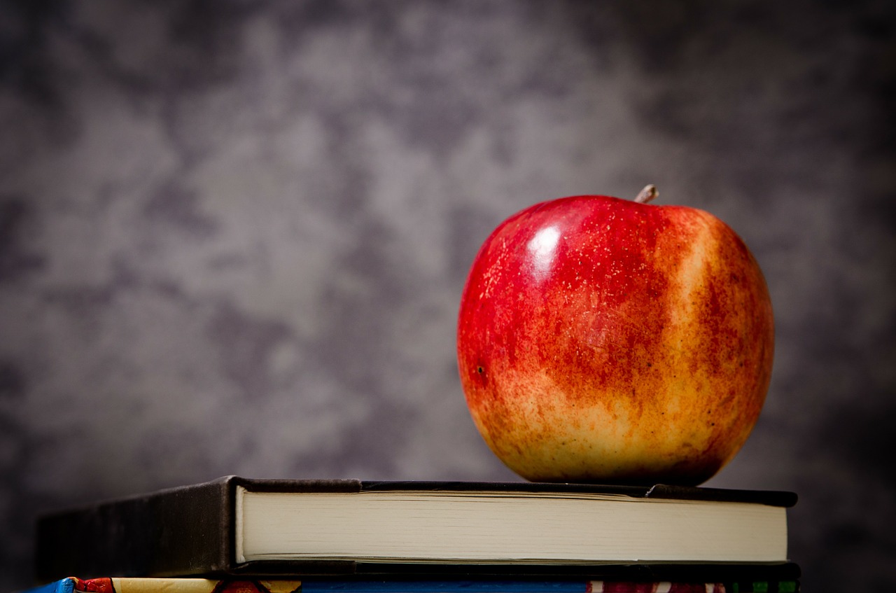 Apple on stack of books