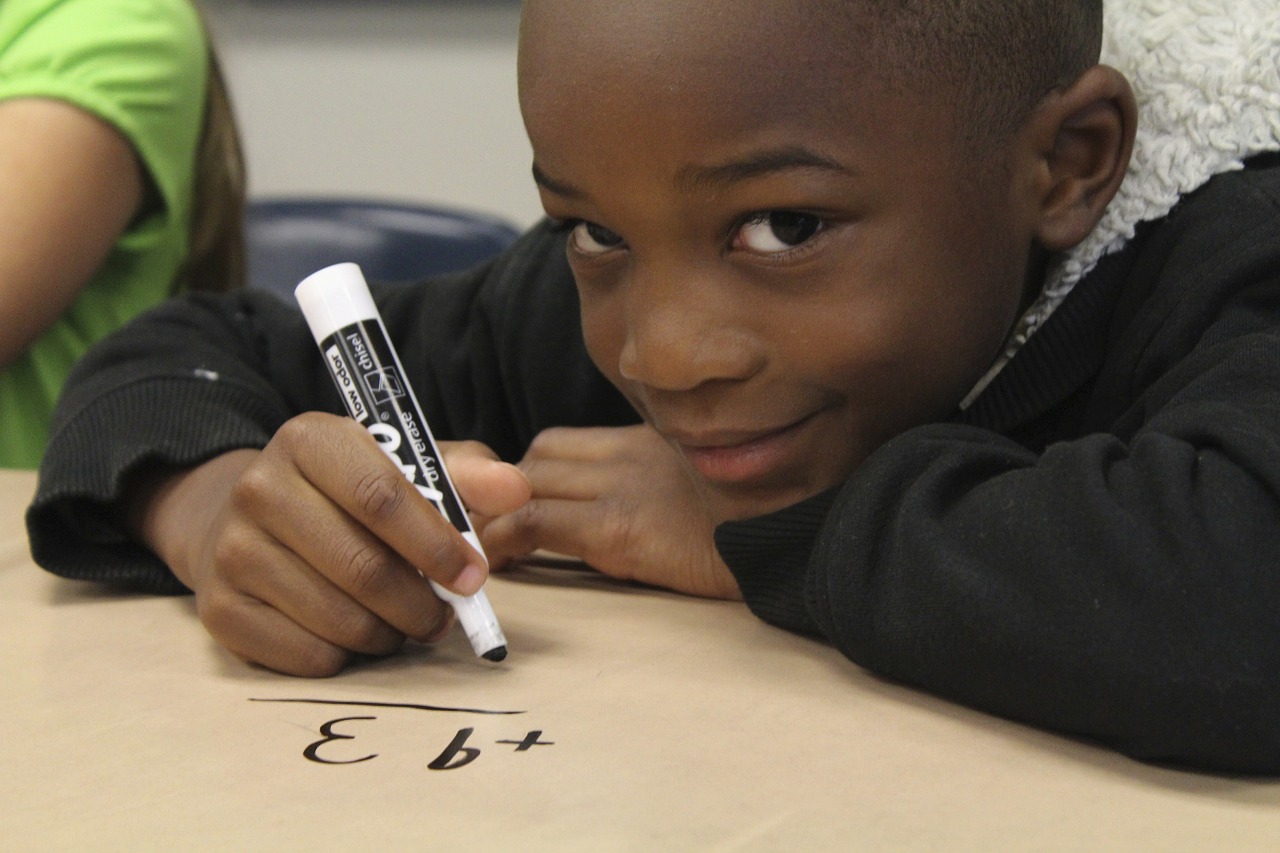 Boy writing a math equation
