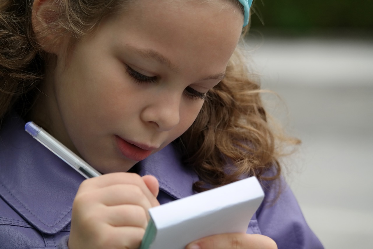 Student writing on notepad