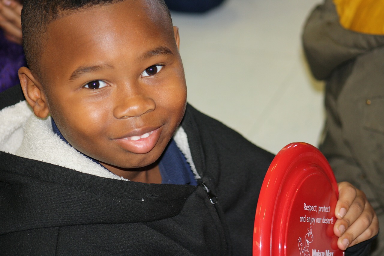 Boy holding a red frisbee