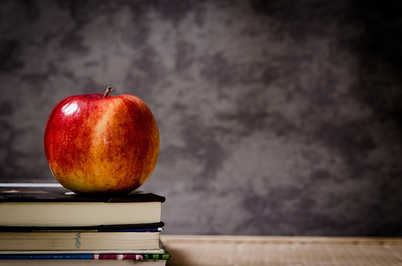 Apple on stack of books