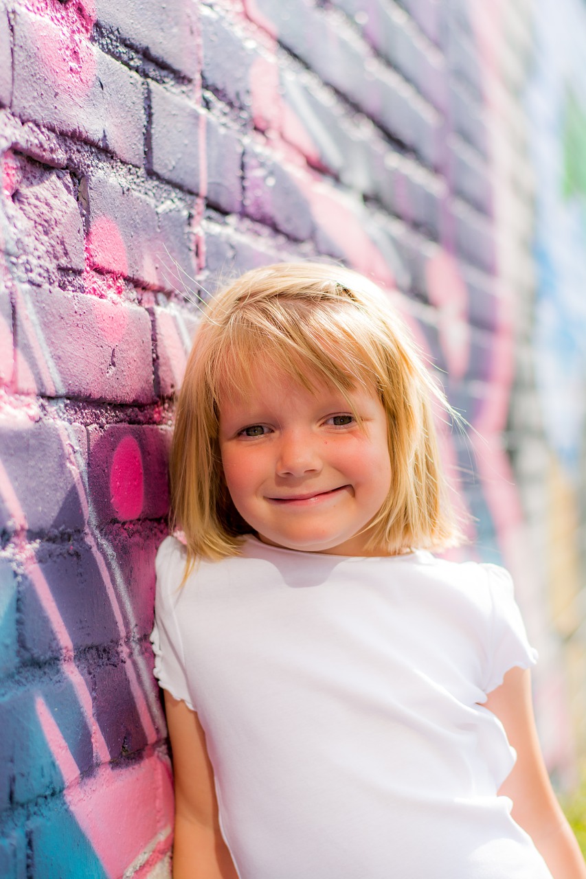 Student leaning against brick wall